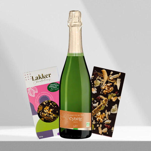 Elegant arrangement of a sparkling wine bottle with two types of artisanal dark chocolate